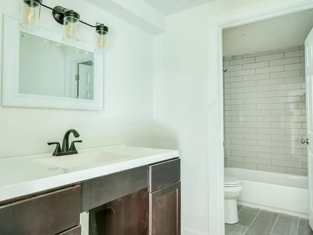 a bathroom with a sink a toilet and a bathtub