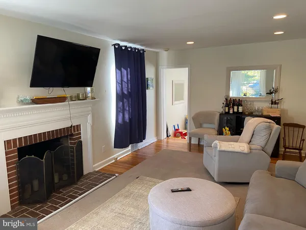 a living room with a fireplace and a flat screen tv