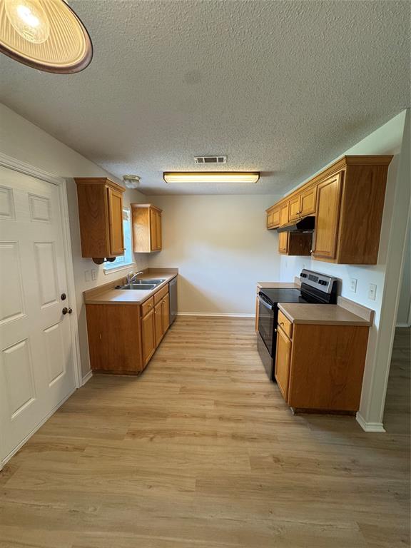 1109 North Riggins Street Anna, TX 75409 - Photo 3 of 11 a view of kitchen with stainless steel appliances a stove a sink and a refrigerator