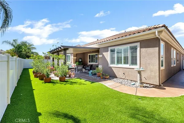 a view of a house with backyard porch and sitting area