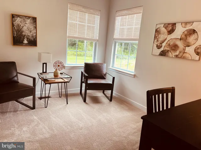 a bed sitting in a spacious bedroom next to a window
