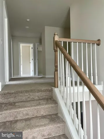 a view of staircase with lots of wooden floor and windows