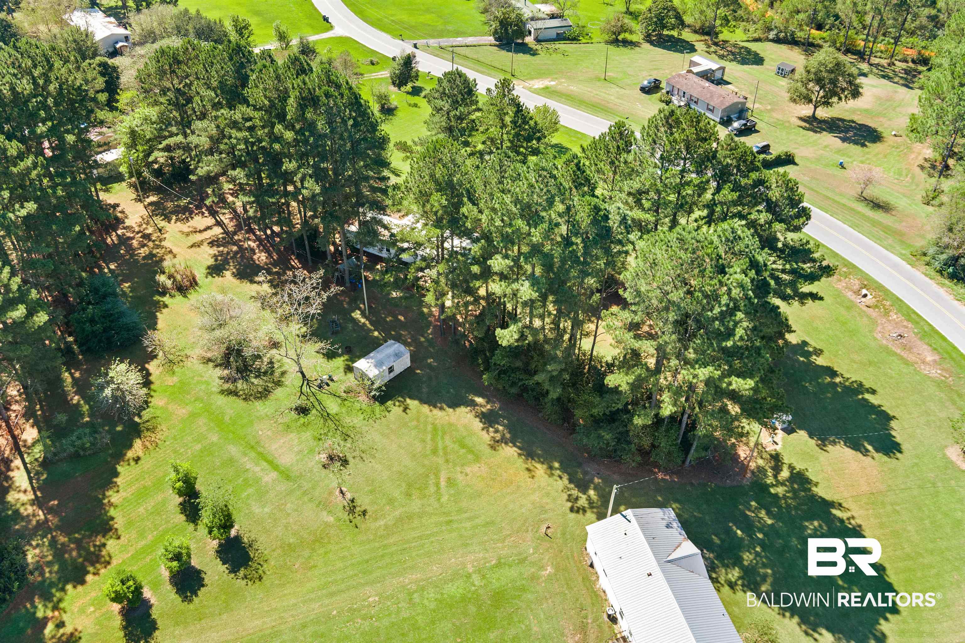 23700 Cumberland Road Robertsdale, AL 36567 - Photo 3 of 33 View of property location featuring a tree filled landscape