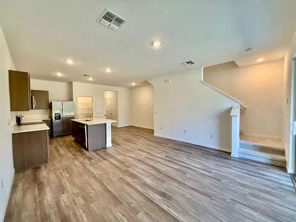 a view of kitchen with kitchen island microwave oven stove and oven
