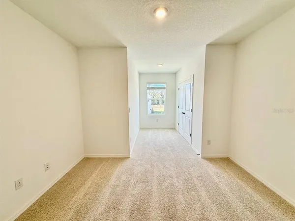 an empty room with a empty space and windows