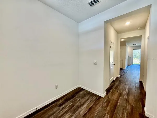 a view of hallway with wooden floor
