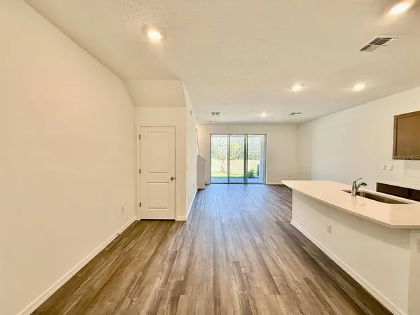 a view of a room with wooden floor and window