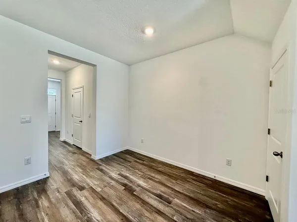 a view of room with wooden floor