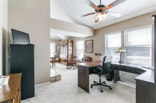 a view of a livingroom with workspace and a window