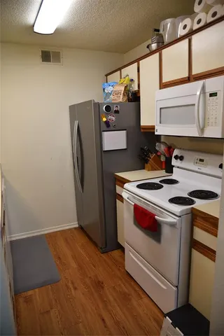 a kitchen with stainless steel appliances a stove a refrigerator and a sink