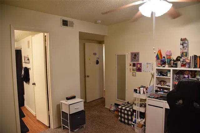 a view of a room with workspace and a window