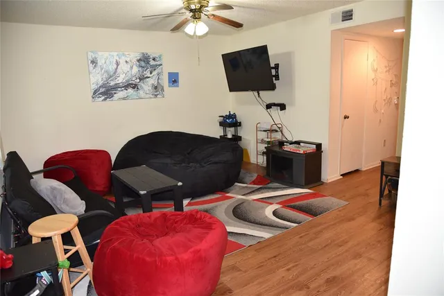 a bedroom with furniture and a flat screen tv