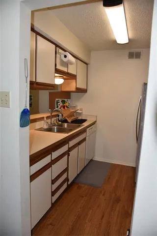 a kitchen with a sink and a mirror