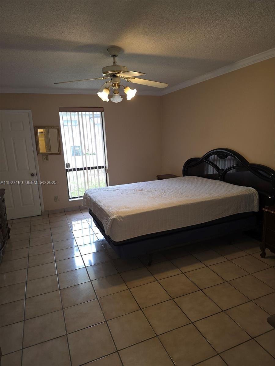 1113 Northeast 2nd Street, Unit 12 Hallandale Beach, FL 33009 - Photo 1 of 6 a bedroom with a bed and a window