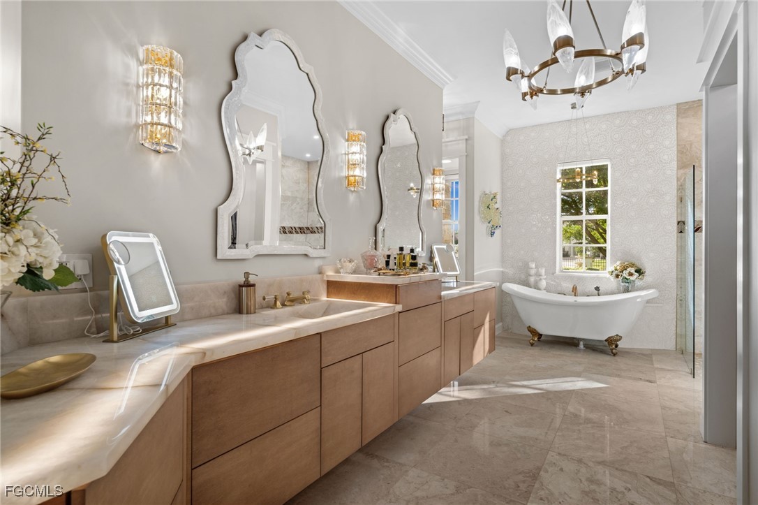 9250 The Lane Naples, FL 34109 - Photo 21 of 50 a spacious bathroom with a double vanity sink mirror and a bathtub