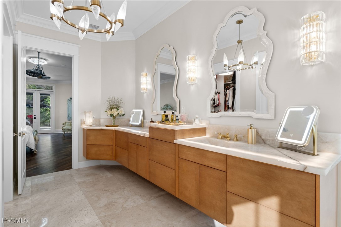 9250 The Lane Naples, FL 34109 - Photo 24 of 50 a bathroom with a double vanity sink and a mirror