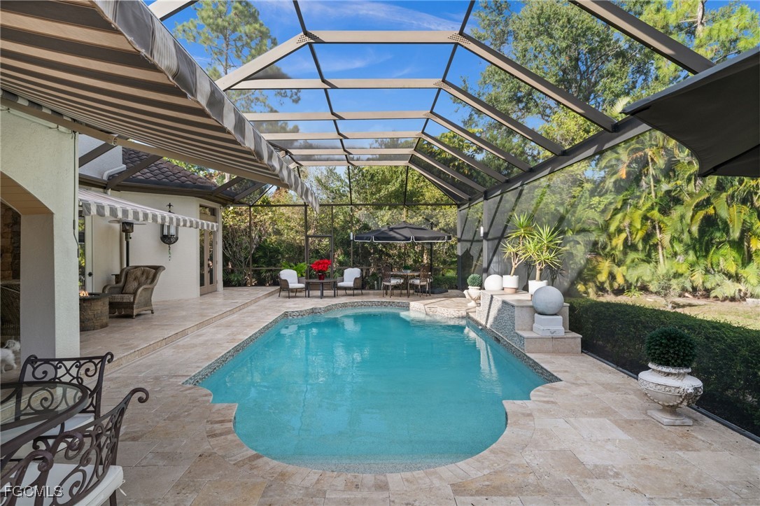9250 The Lane Naples, FL 34109 - Photo 26 of 50 a swimming pool with outdoor seating