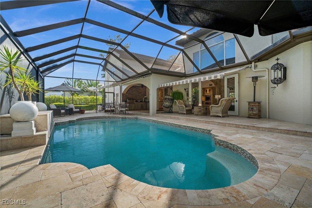 9250 The Lane Naples, FL 34109 - Photo 27 of 50 a view of a swimming pool with a patio