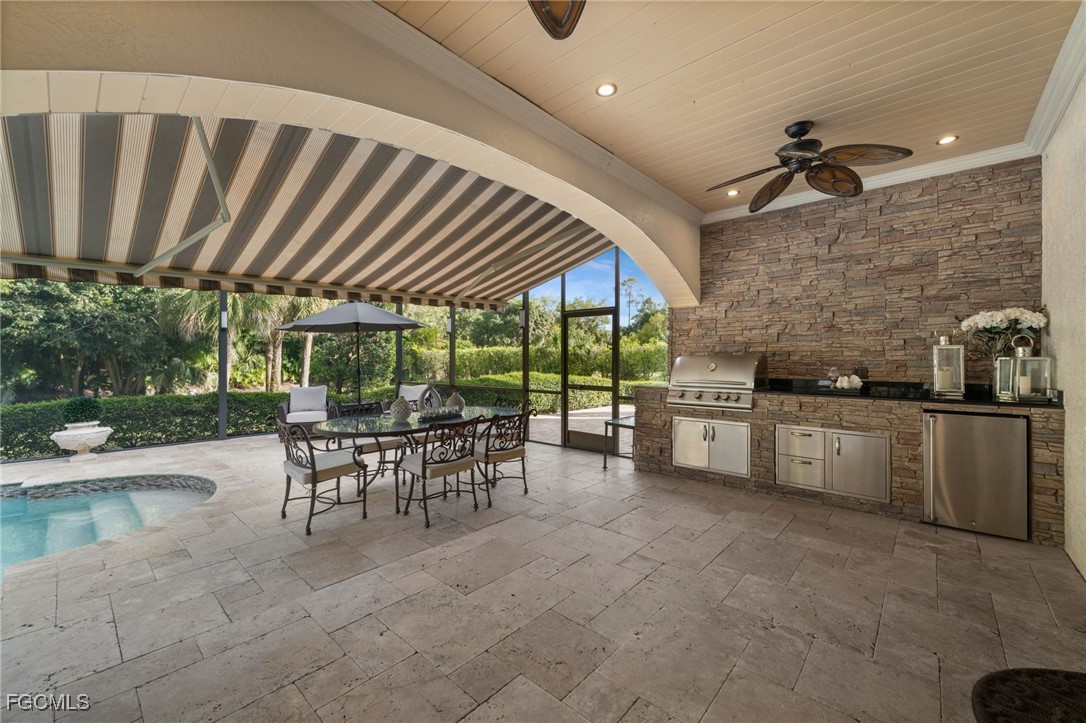 9250 The Lane Naples, FL 34109 - Photo 28 of 50 a dining room with furniture and a kitchen view