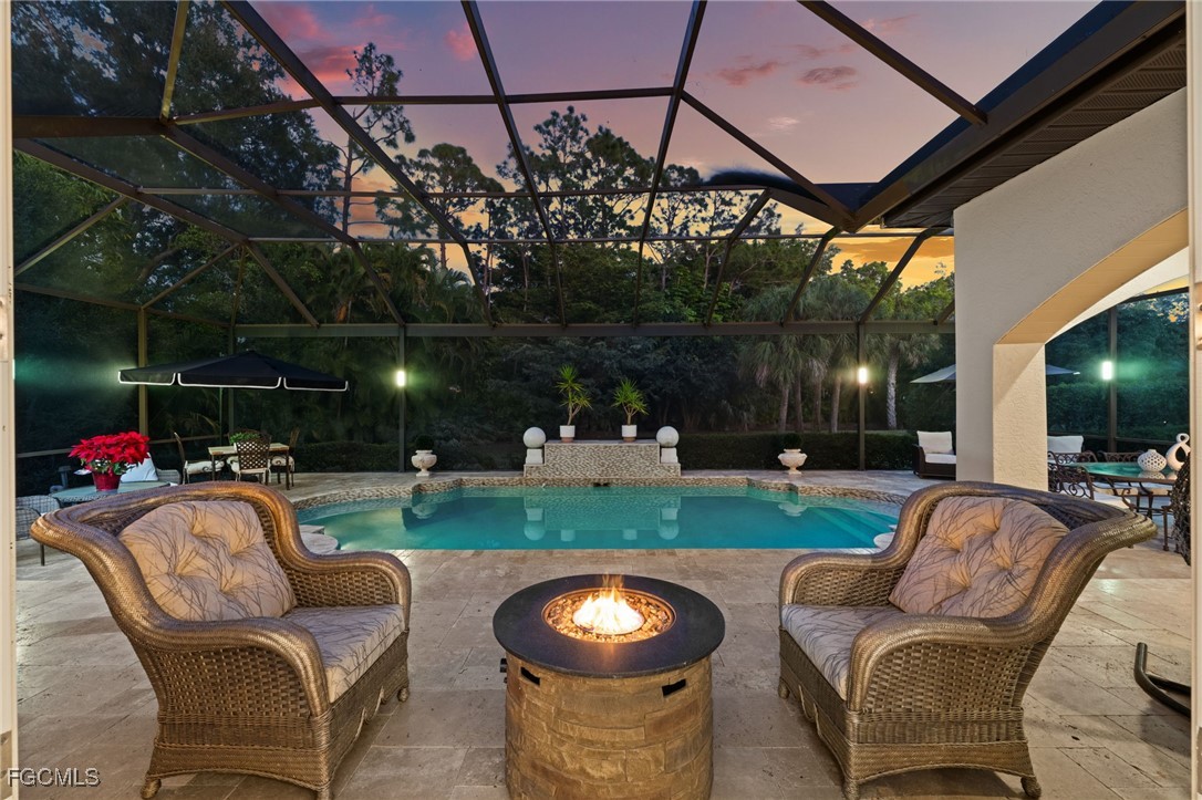 9250 The Lane Naples, FL 34109 - Photo 30 of 50 a view of a patio with couches chairs and a yard