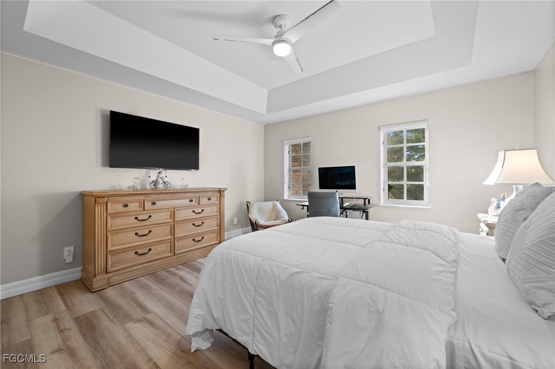 9250 The Lane Naples, FL 34109 - Photo 35 of 50 a bedroom with a bed a flat screen tv and a fish tank