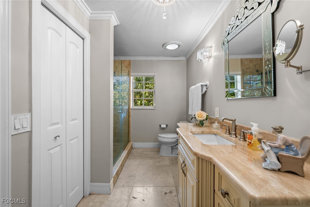 9250 The Lane Naples, FL 34109 - Photo 36 of 50 a bathroom with a sink toilet and shower