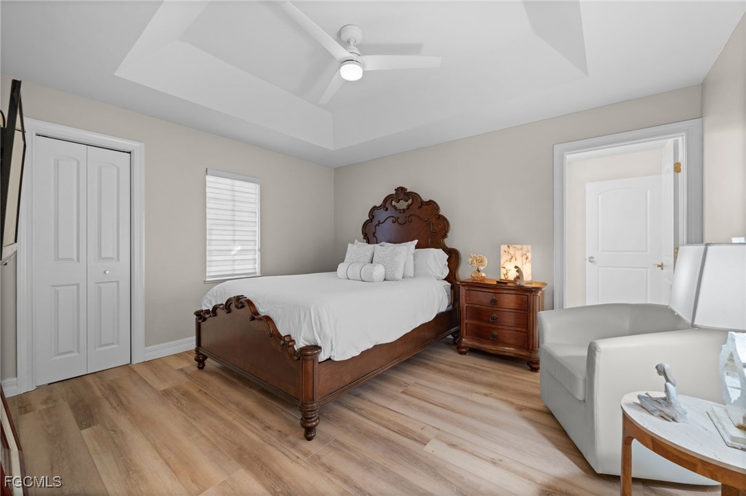 9250 The Lane Naples, FL 34109 - Photo 39 of 50 a spacious bedroom with a bed and a couch