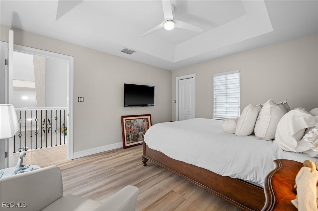 9250 The Lane Naples, FL 34109 - Photo 40 of 50 a bedroom with a bed and a flat screen tv