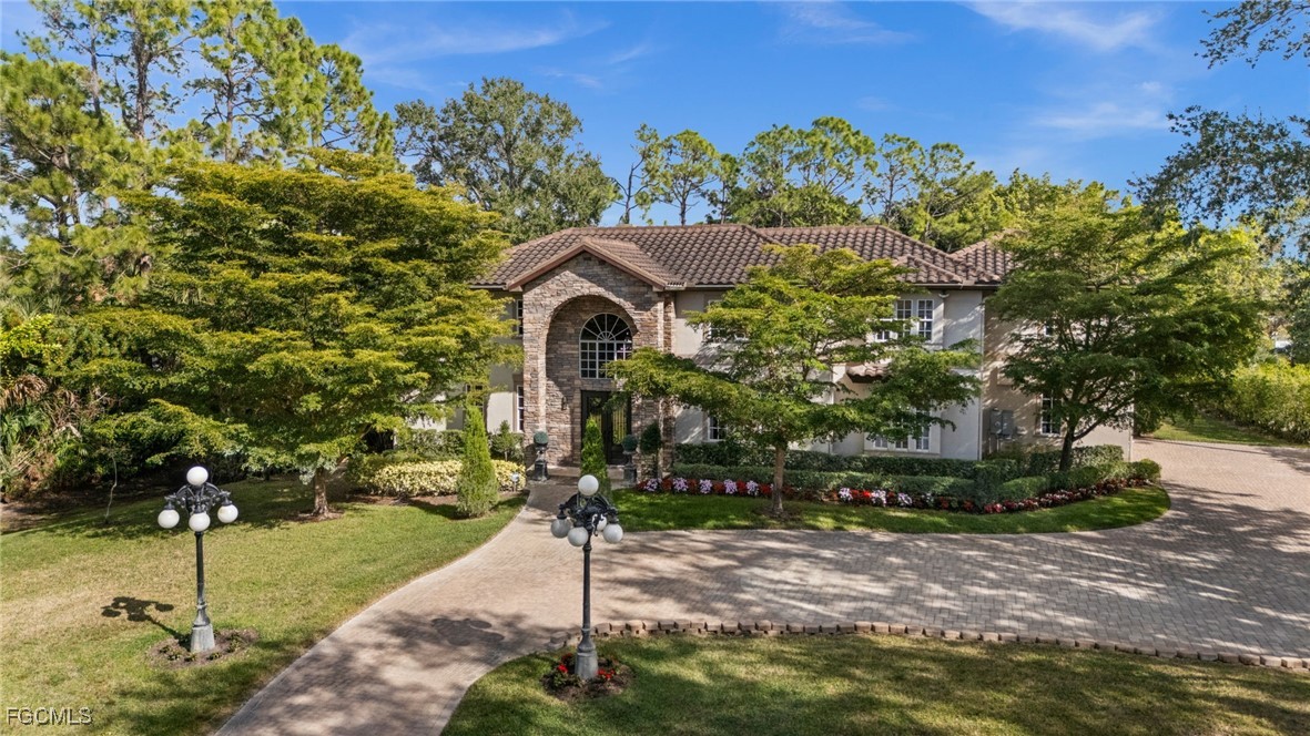 9250 The Lane Naples, FL 34109 - Photo 45 of 50 a front view of a house with a yard