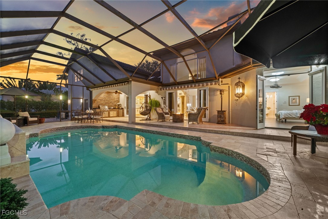 9250 The Lane Naples, FL 34109 - Photo 5 of 50 a view of a swimming pool with a patio