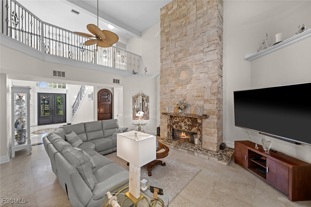 9250 The Lane Naples, FL 34109 - Photo 10 of 50 a living room with furniture a flat screen tv and kitchen view