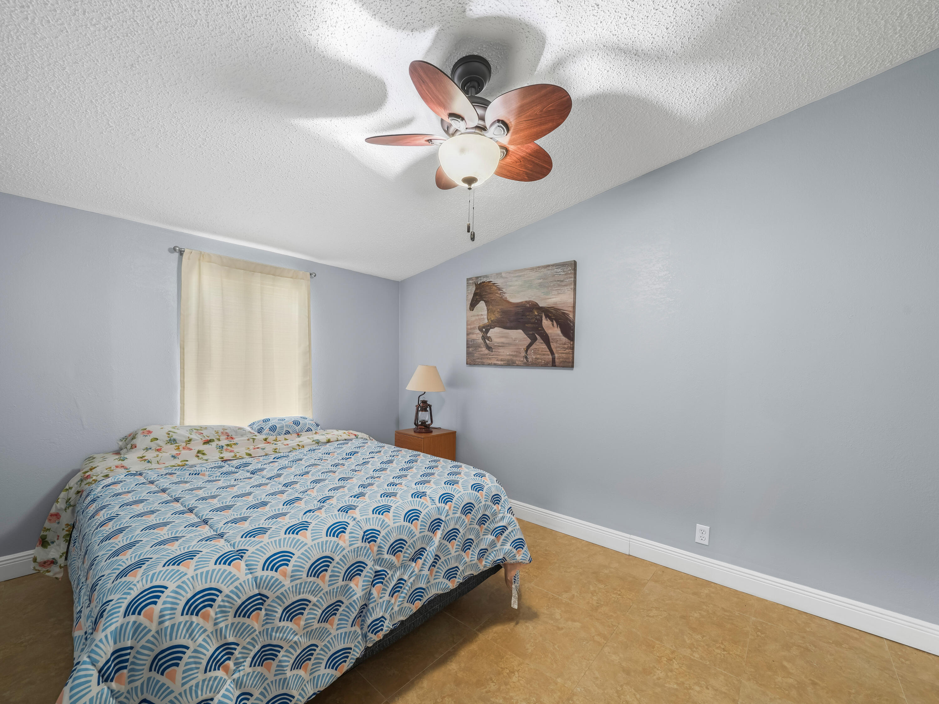329 Kilpatrick Loop Clewiston, FL 33440 - Photo 14 of 56 a bedroom with a bed and a chandelier