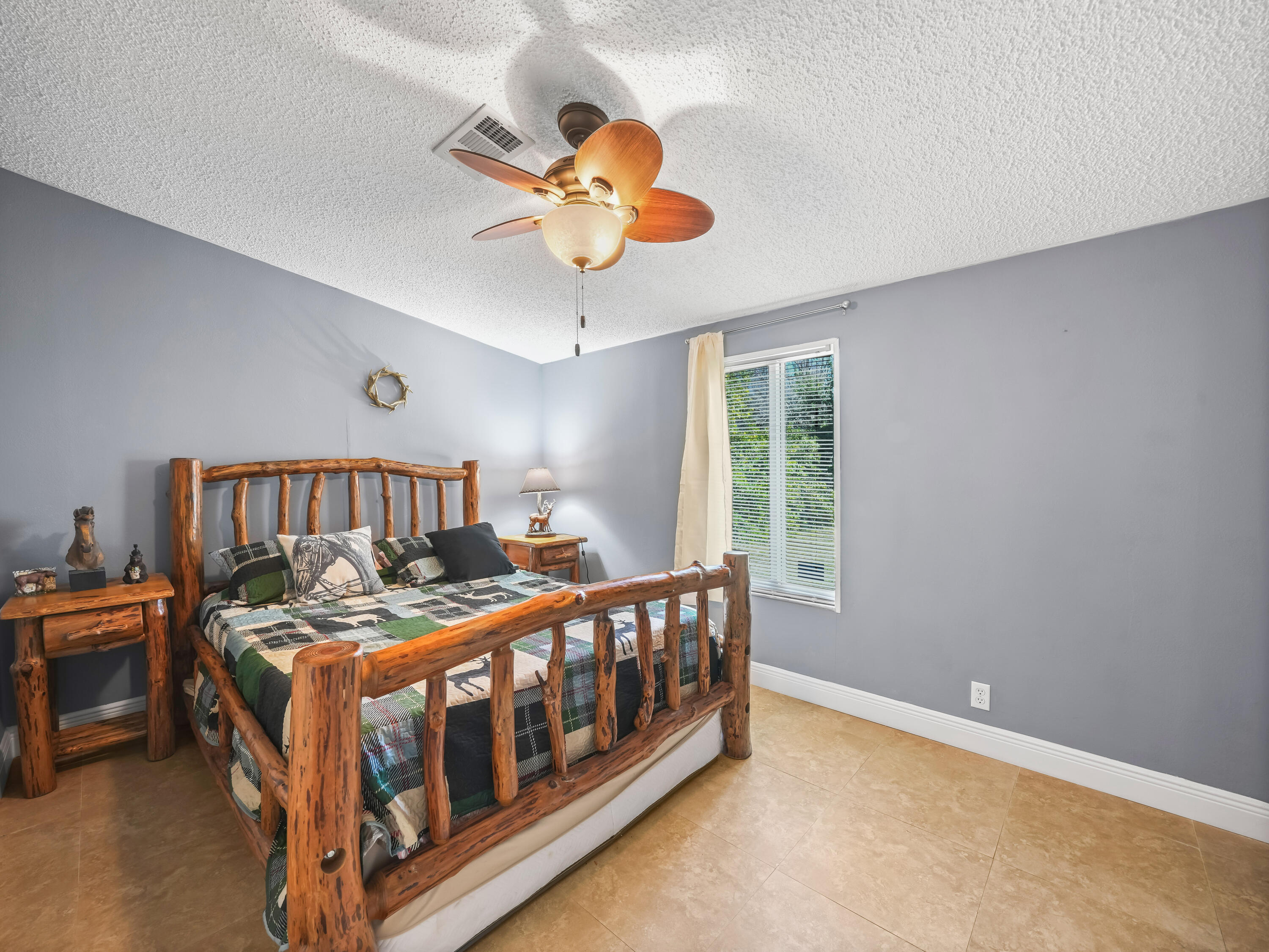 329 Kilpatrick Loop Clewiston, FL 33440 - Photo 16 of 56 a bedroom with a bed and a chandelier