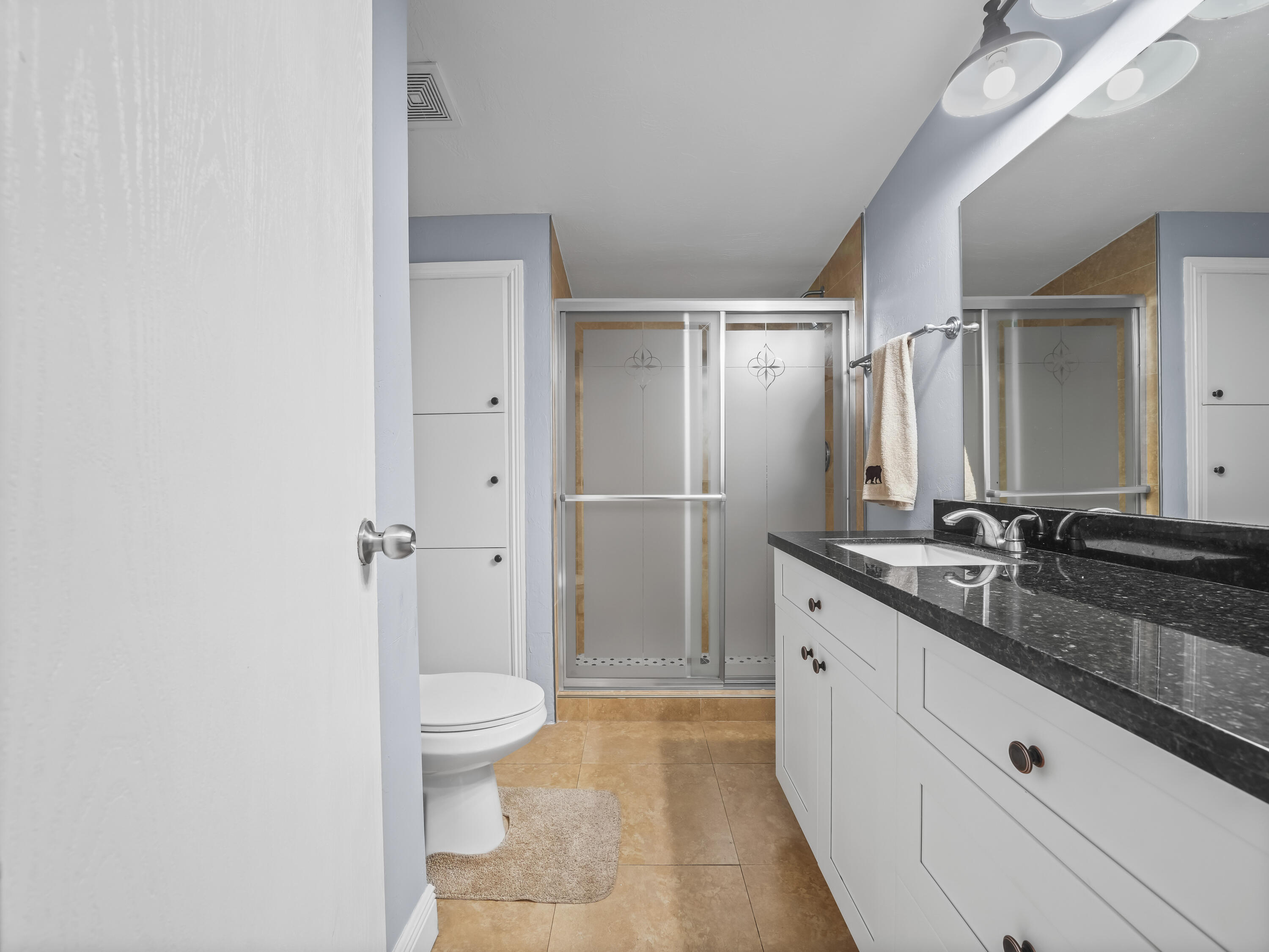 329 Kilpatrick Loop Clewiston, FL 33440 - Photo 18 of 56 a spacious bathroom with a granite countertop sink a toilet and a shower