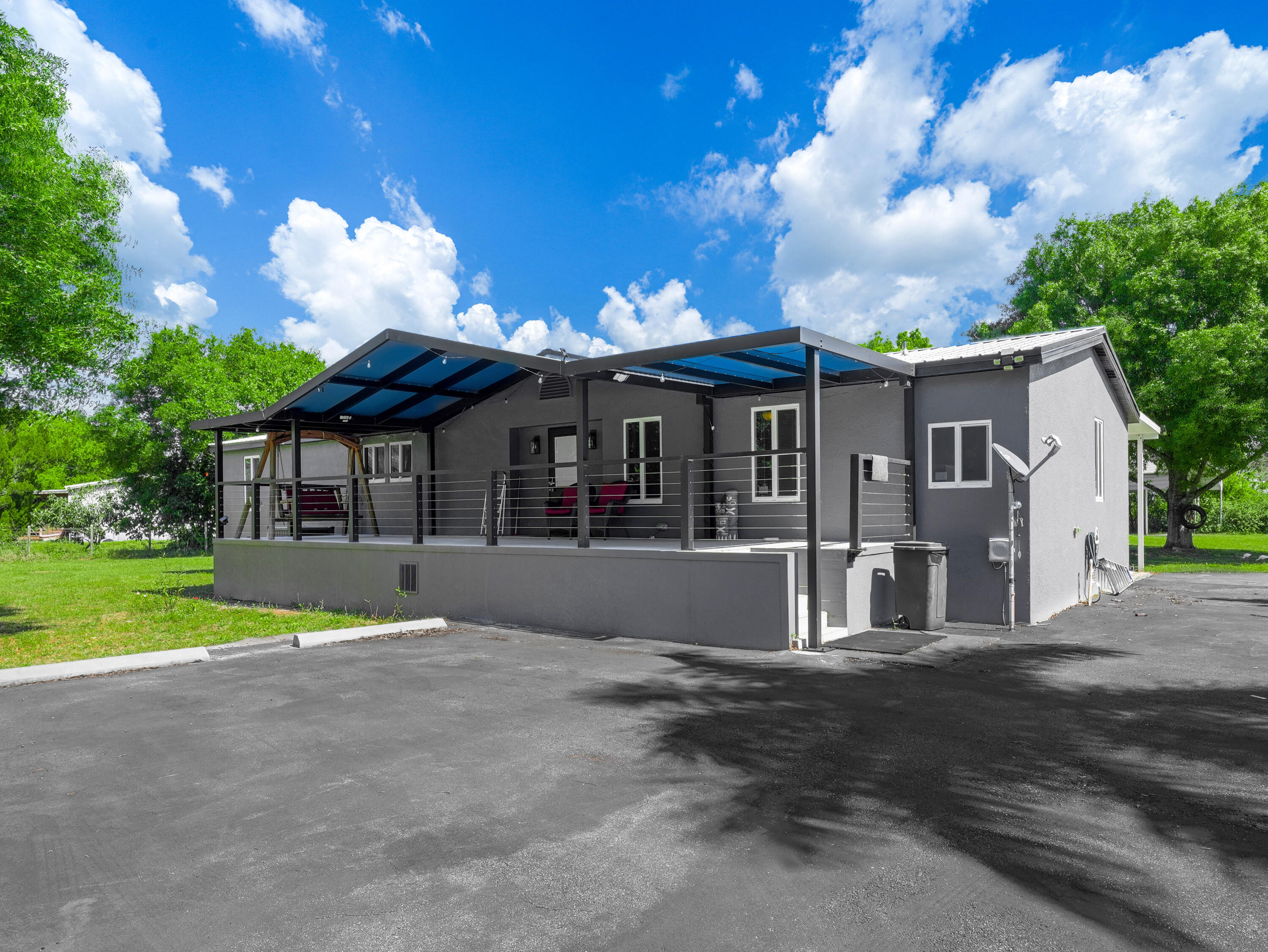 329 Kilpatrick Loop Clewiston, FL 33440 - Photo 2 of 56 a view of house with a yard and a large tree