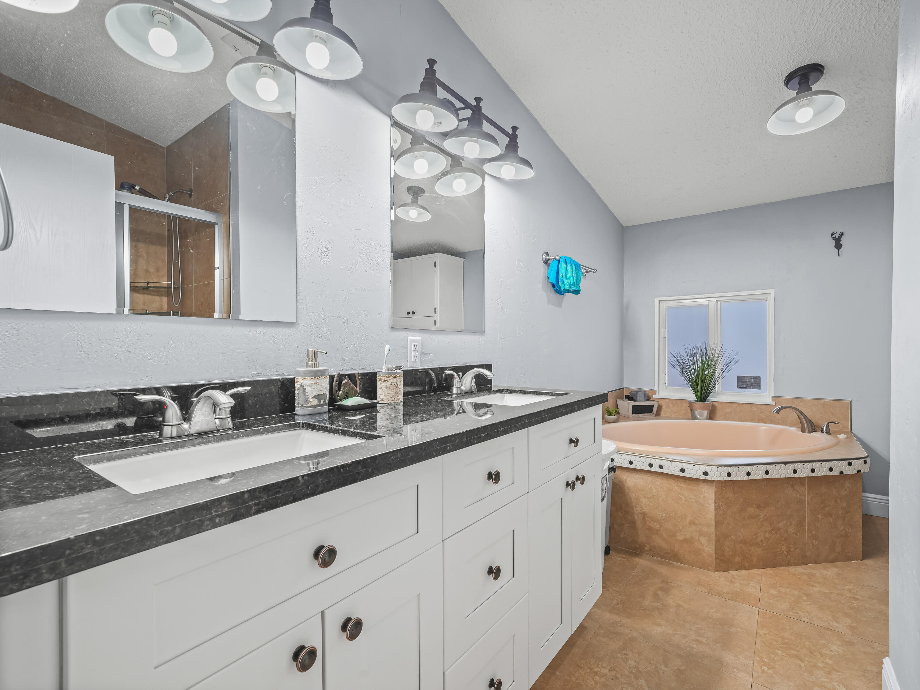 329 Kilpatrick Loop Clewiston, FL 33440 - Photo 22 of 56 a spacious bathroom with a double vanity sink and a mirror