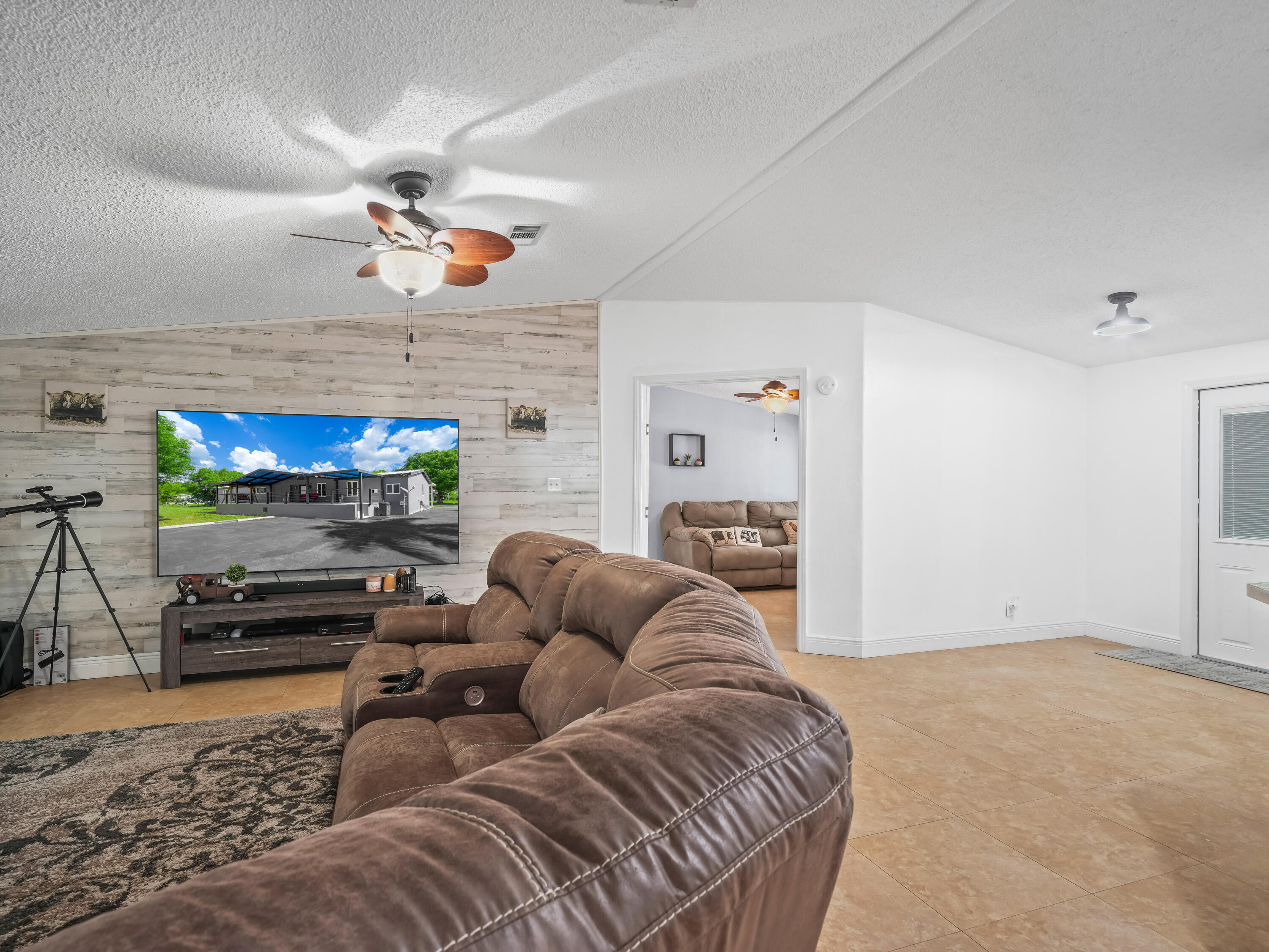 329 Kilpatrick Loop Clewiston, FL 33440 - Photo 5 of 56 a living room with furniture a fireplace and a flat screen tv