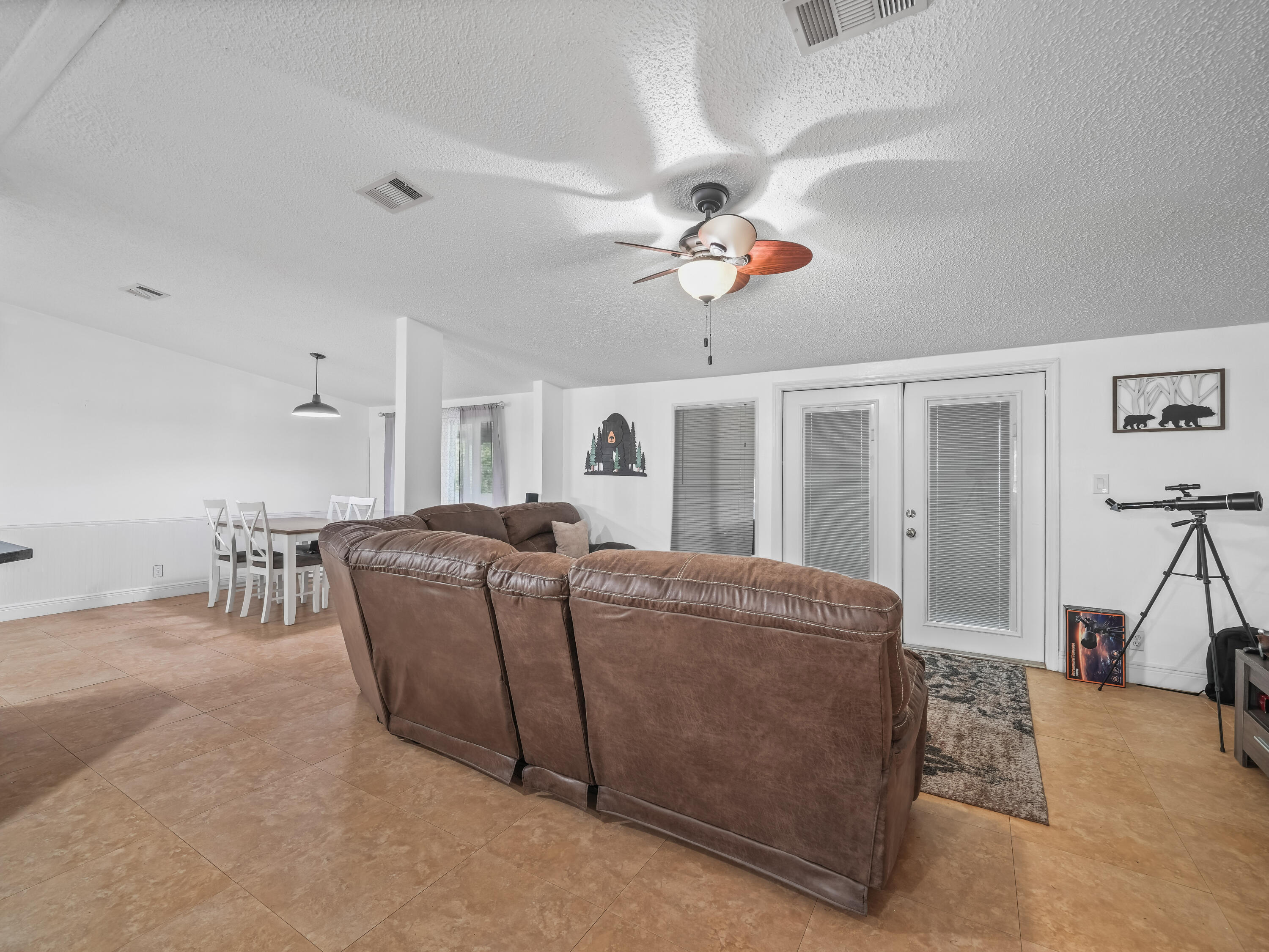 329 Kilpatrick Loop Clewiston, FL 33440 - Photo 7 of 56 a living room with furniture a two couches and a chandelier