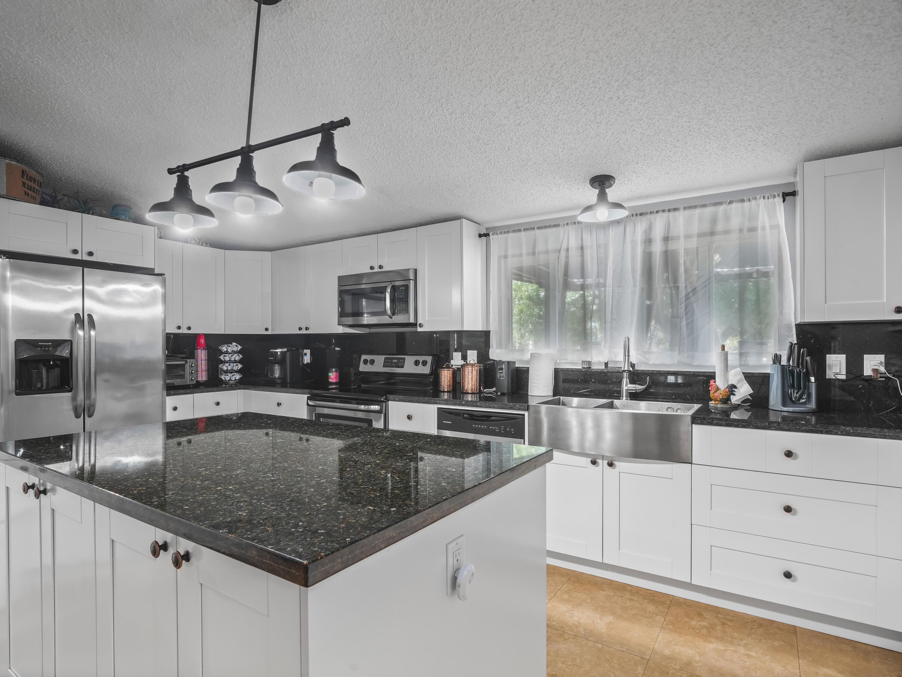 329 Kilpatrick Loop Clewiston, FL 33440 - Photo 9 of 56 a kitchen with stainless steel appliances granite countertop a sink a stove and cabinets