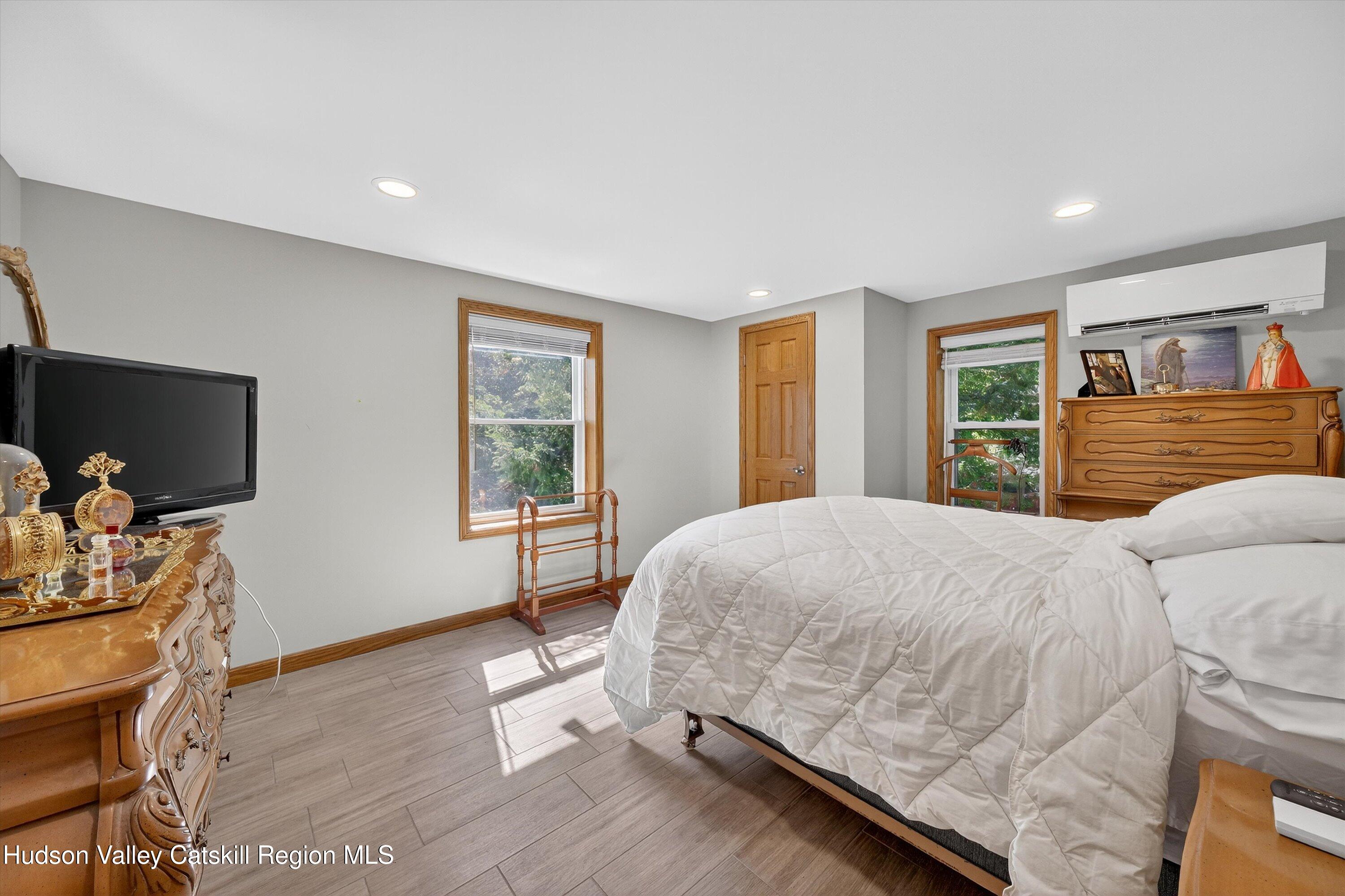 6 Hasbrouck Place New Paltz, NY 12561 - Photo 13 of 38 a bedroom with a bed and a flat screen tv