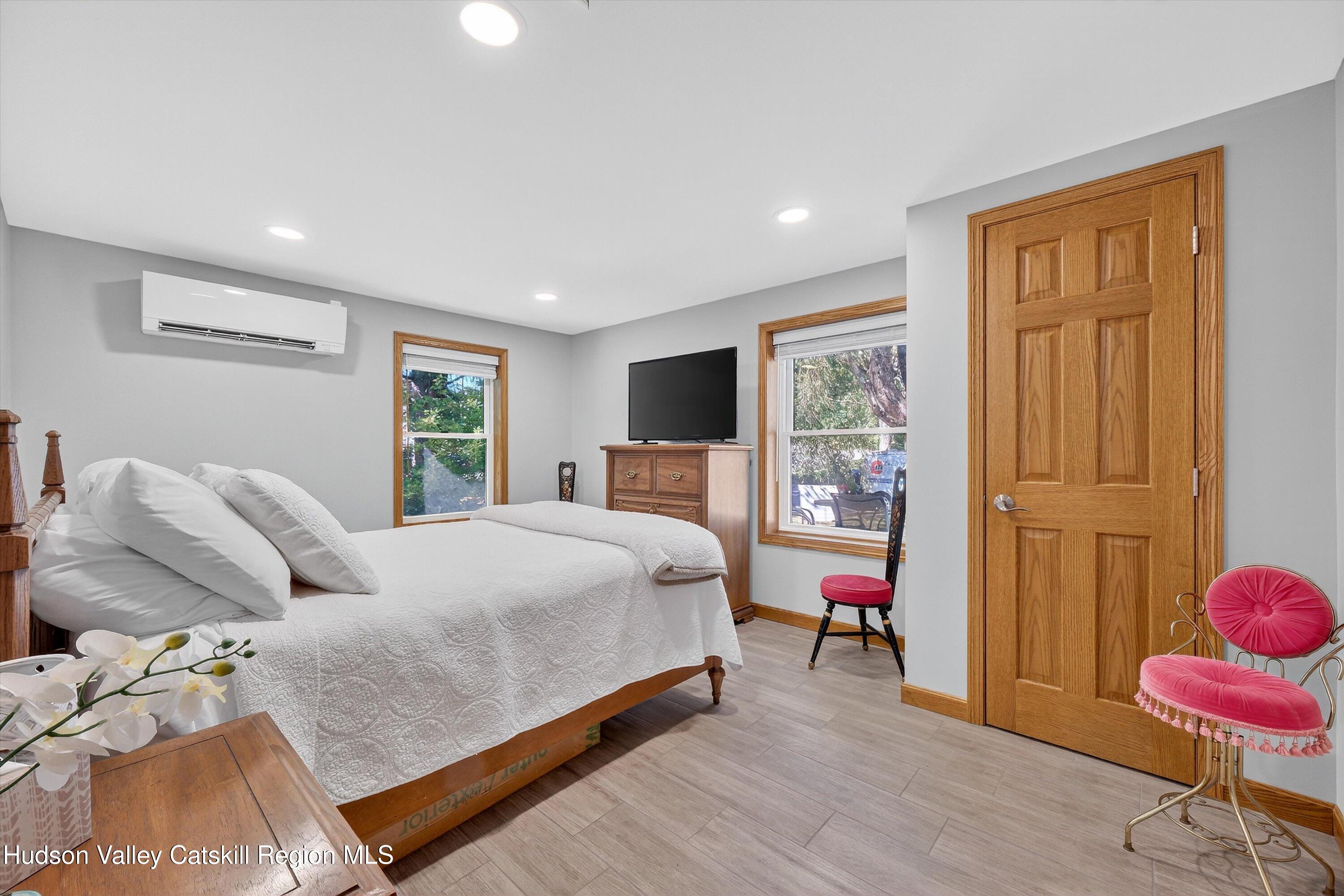 6 Hasbrouck Place New Paltz, NY 12561 - Photo 14 of 38 a bedroom with a bed and wooden floor