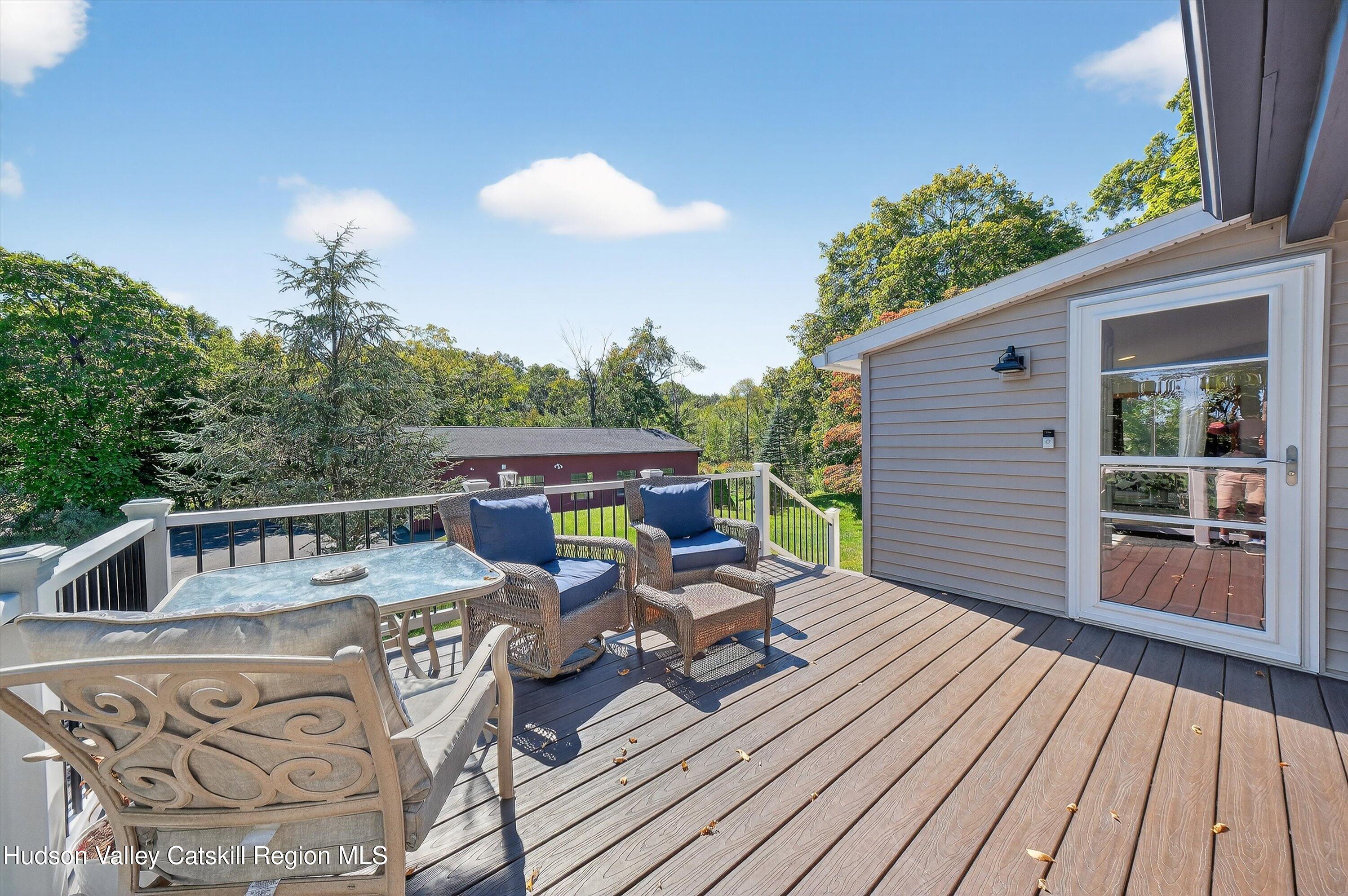 6 Hasbrouck Place New Paltz, NY 12561 - Photo 17 of 38 a view of a chairs and table on the wooden roof deck