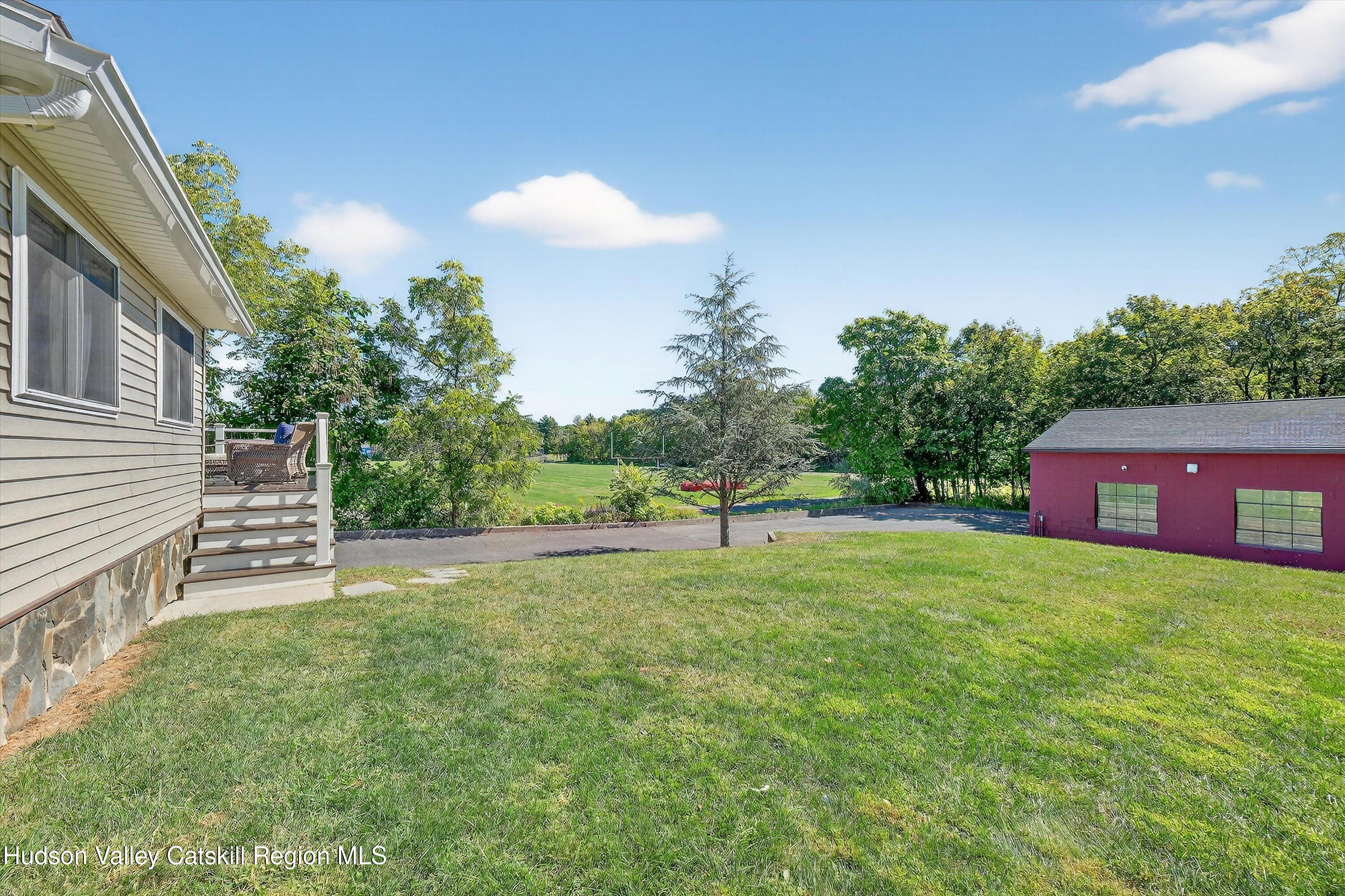 6 Hasbrouck Place New Paltz, NY 12561 - Photo 19 of 38 a view of an house with backyard and a tree