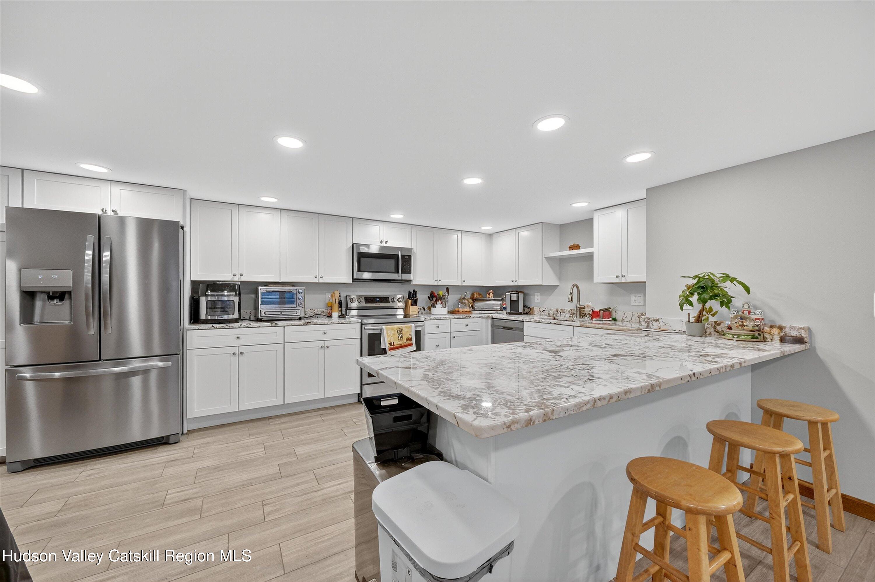 6 Hasbrouck Place New Paltz, NY 12561 - Photo 22 of 38 a kitchen with stainless steel appliances granite countertop a sink counter space and refrigerator