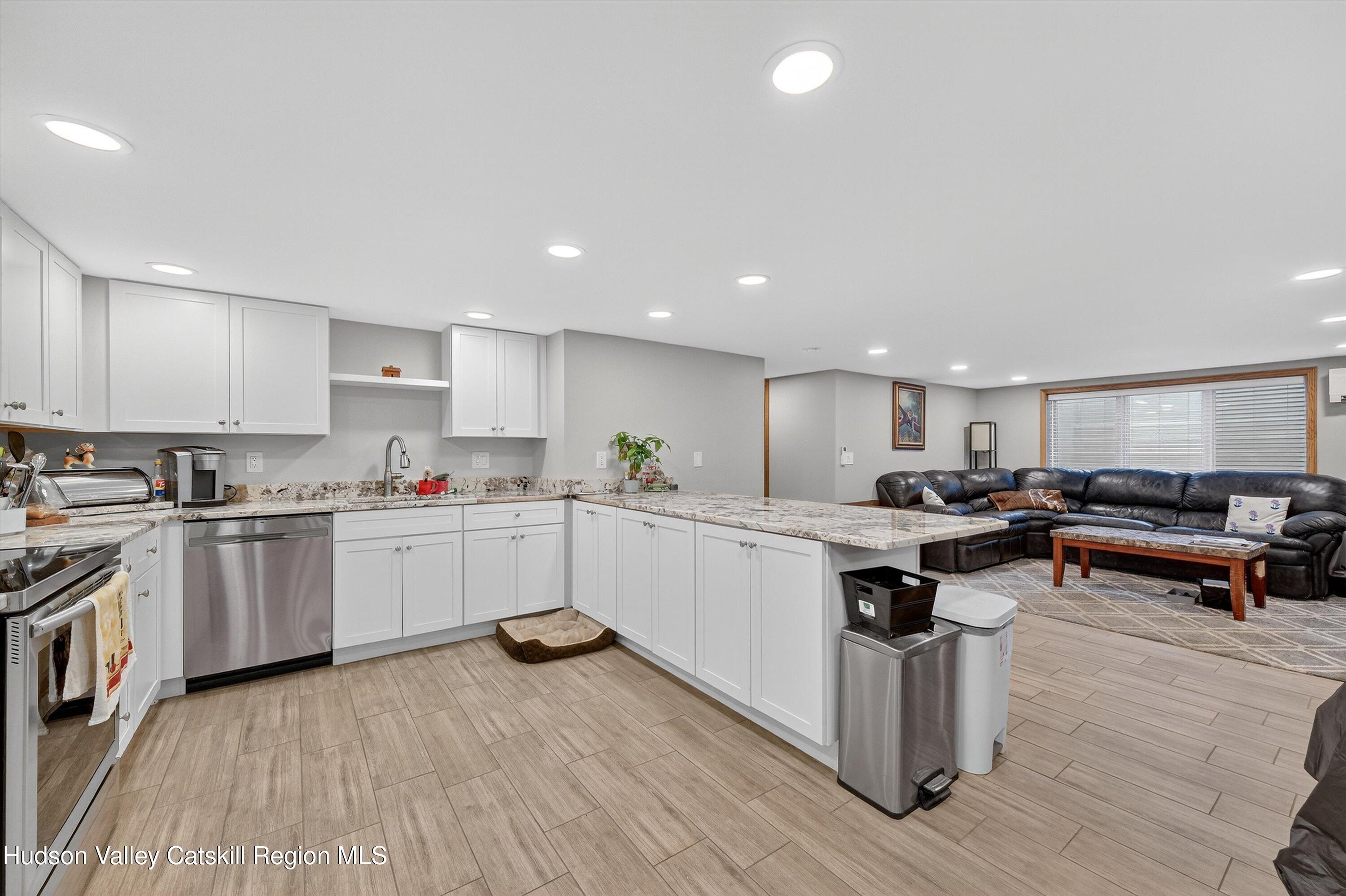 6 Hasbrouck Place New Paltz, NY 12561 - Photo 24 of 38 a kitchen with a sink and wooden cabinets