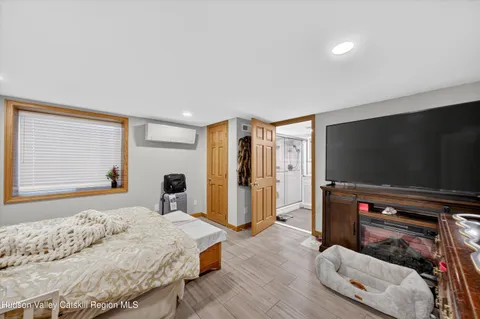 a bedroom with a bed and a flat screen tv