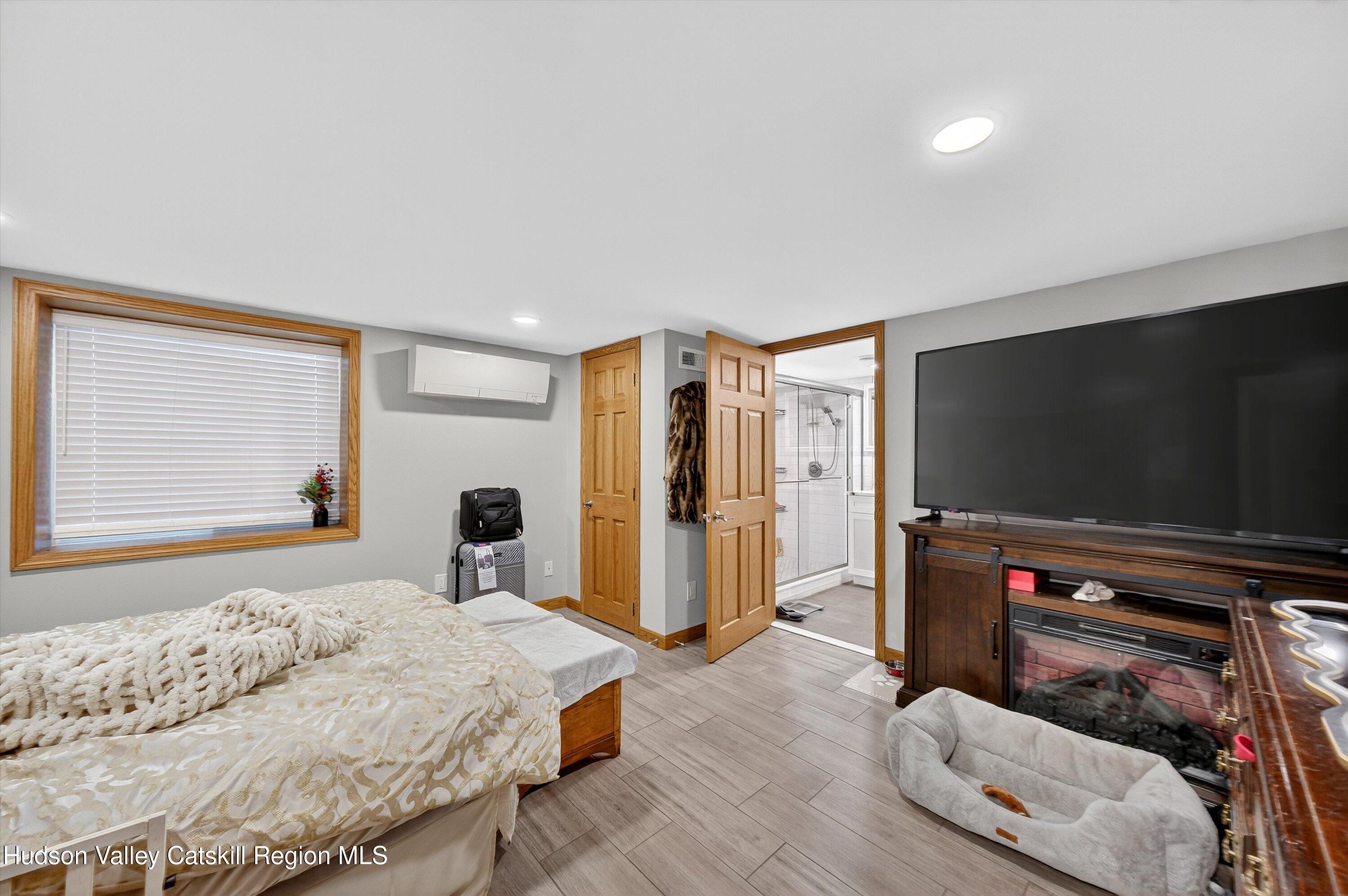 6 Hasbrouck Place New Paltz, NY 12561 - Photo 26 of 38 a bedroom with a bed and a flat screen tv