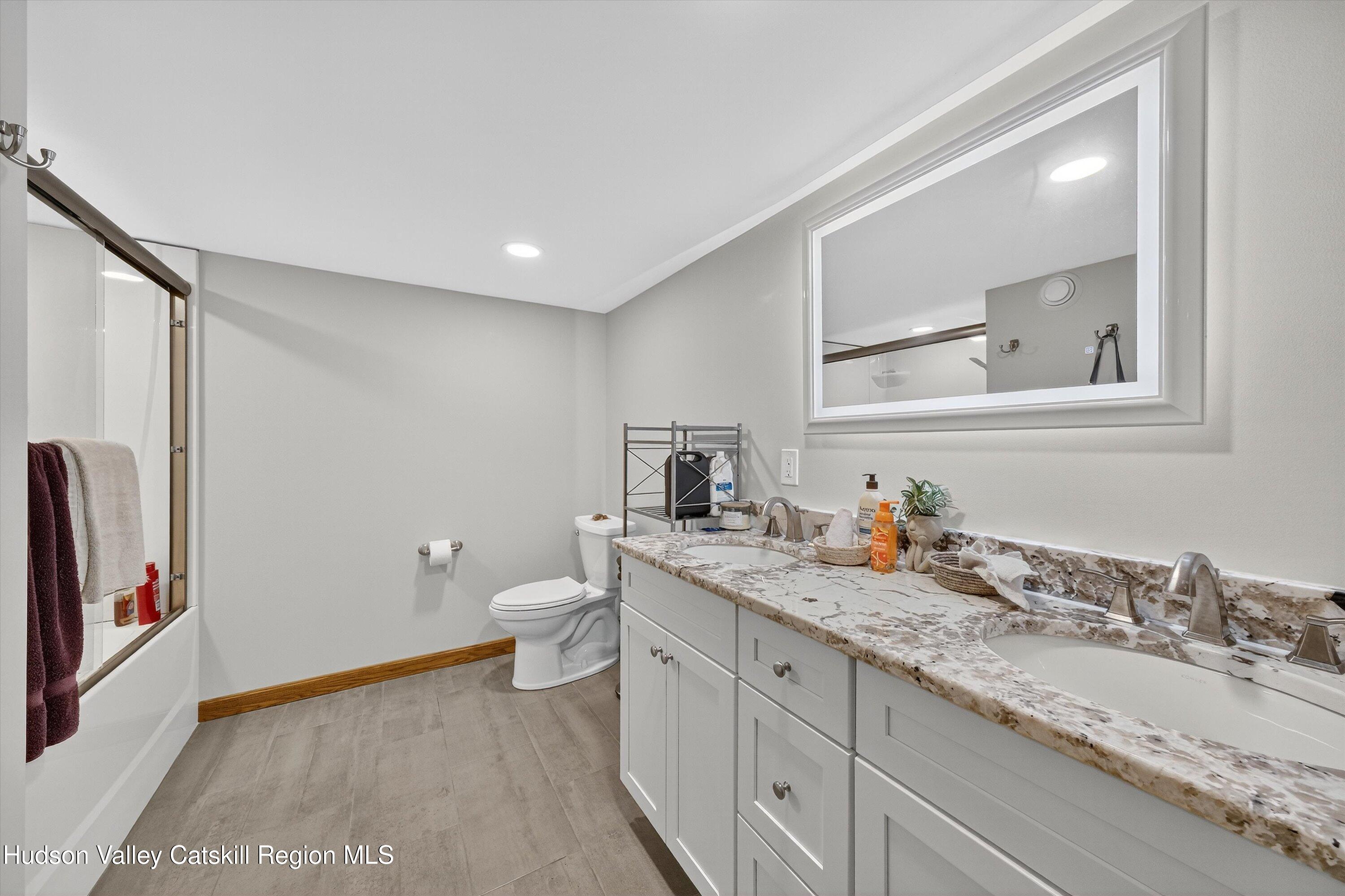 6 Hasbrouck Place New Paltz, NY 12561 - Photo 29 of 38 a bathroom with a granite countertop sink toilet and shower