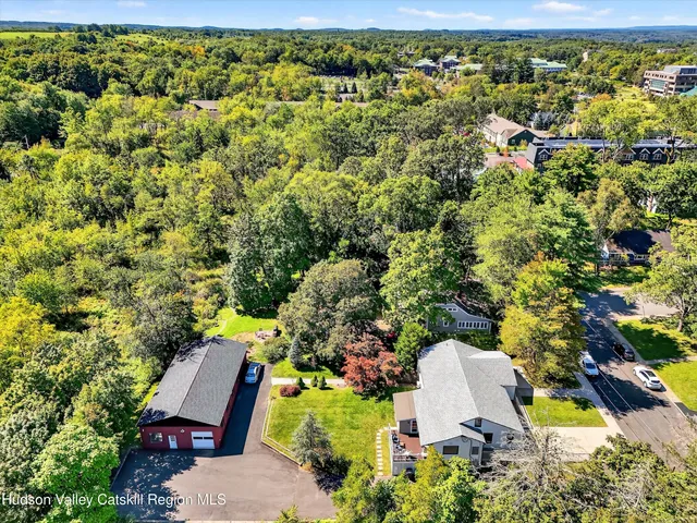 an aerial view of a house with yard swimming pool and outdoor seating