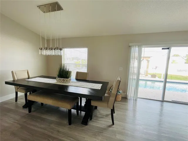 a view of a dining room with furniture window and wooden floor